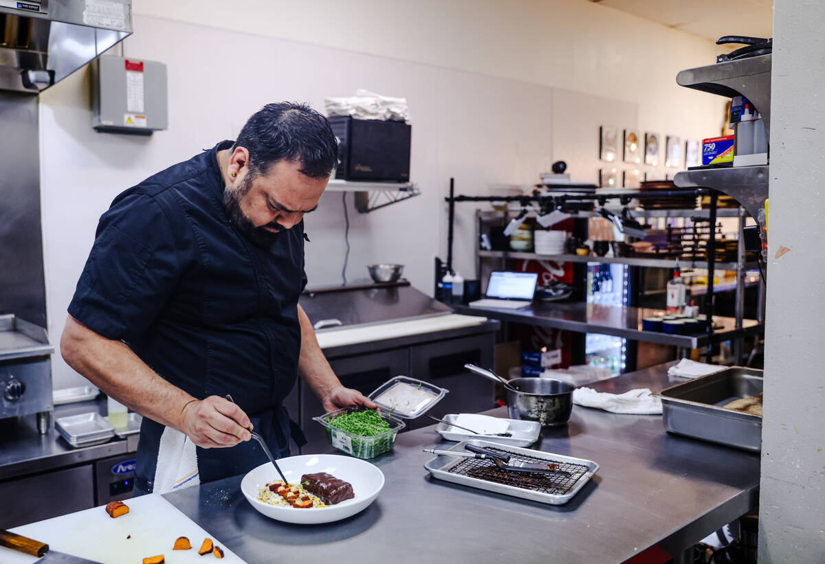 Chef and owner Steve Kestler prepares beef short ribs with mole, roasted sweet potatoes and esq ...