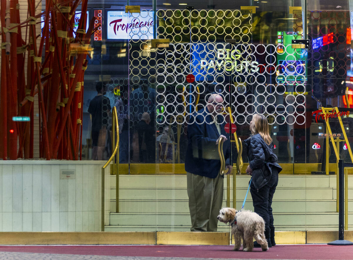 A woman talks with security personnel at the main door as the final night of gaming has conclud ...