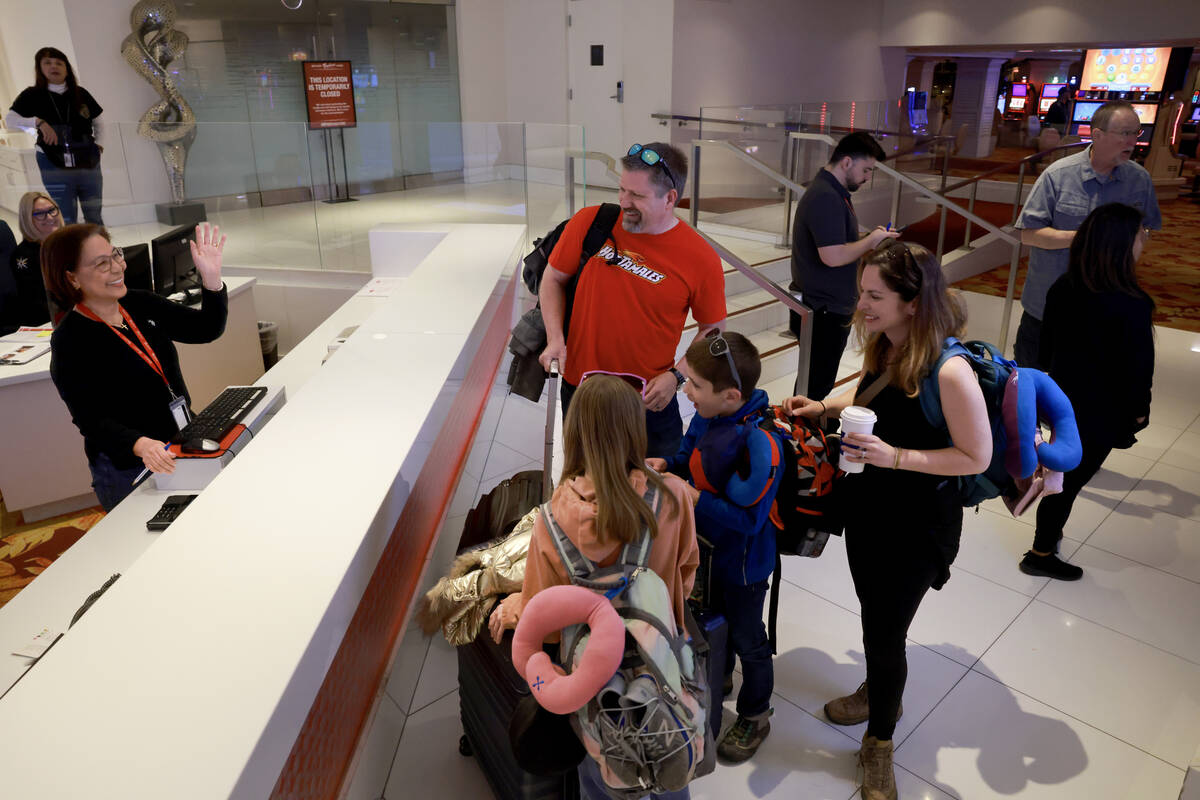 Melanda Alcairo, who has worked at the Tropicana front desk for 21 years, waves goodbye to Todd ...