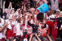 North Carolina State's DJ Burns Jr. (30) dumps confetti on head coach Kevin Keatts following an ...