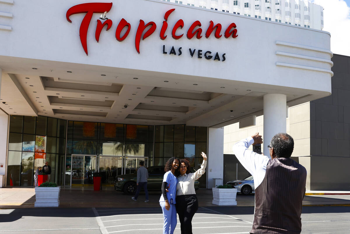 Negusse Lama takes a picture of his daughter Rim and his wife Regbe, center, who worked at Trop ...
