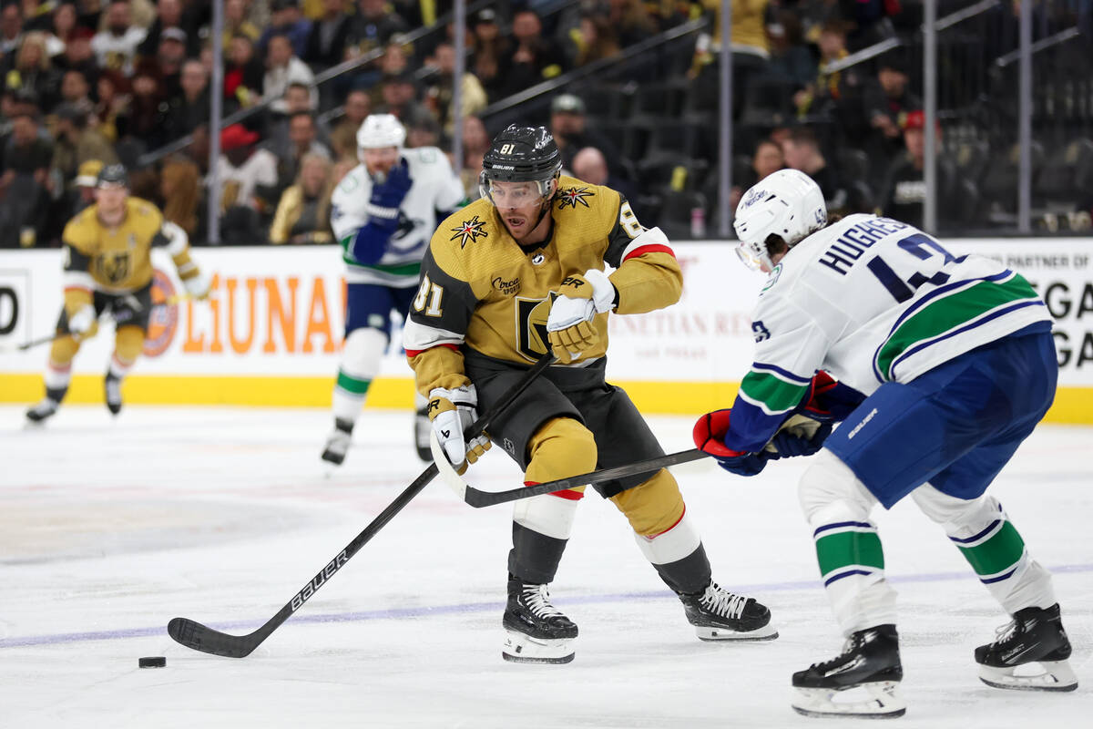 Golden Knights right wing Jonathan Marchessault (81) stats with the puck against Canucks defens ...