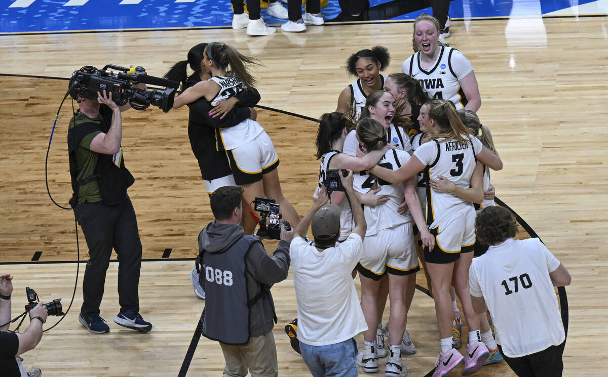 Iowa players celebrate after Iowa defeated LSU in an Elite Eight round college basketball game ...