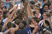 FILE - Kansas' Danny Manning, facing camera left of center, is mobbed by fans and teammates aft ...