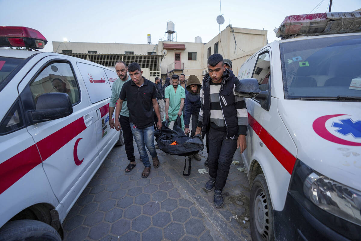 Palestinians carry the body of a World Central Kitchen worker at Al Aqsa hospital in Deir al-Ba ...