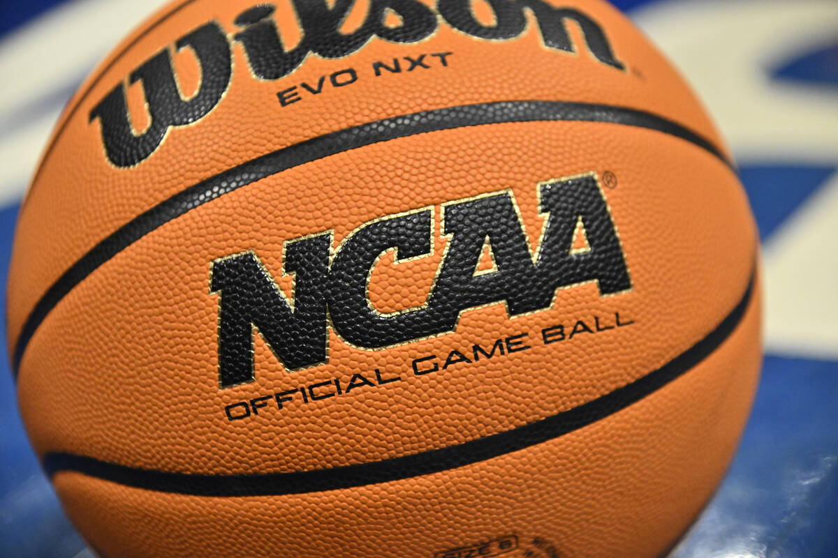 An official game ball sits on the court during the second half of an NCAA college basketball ga ...