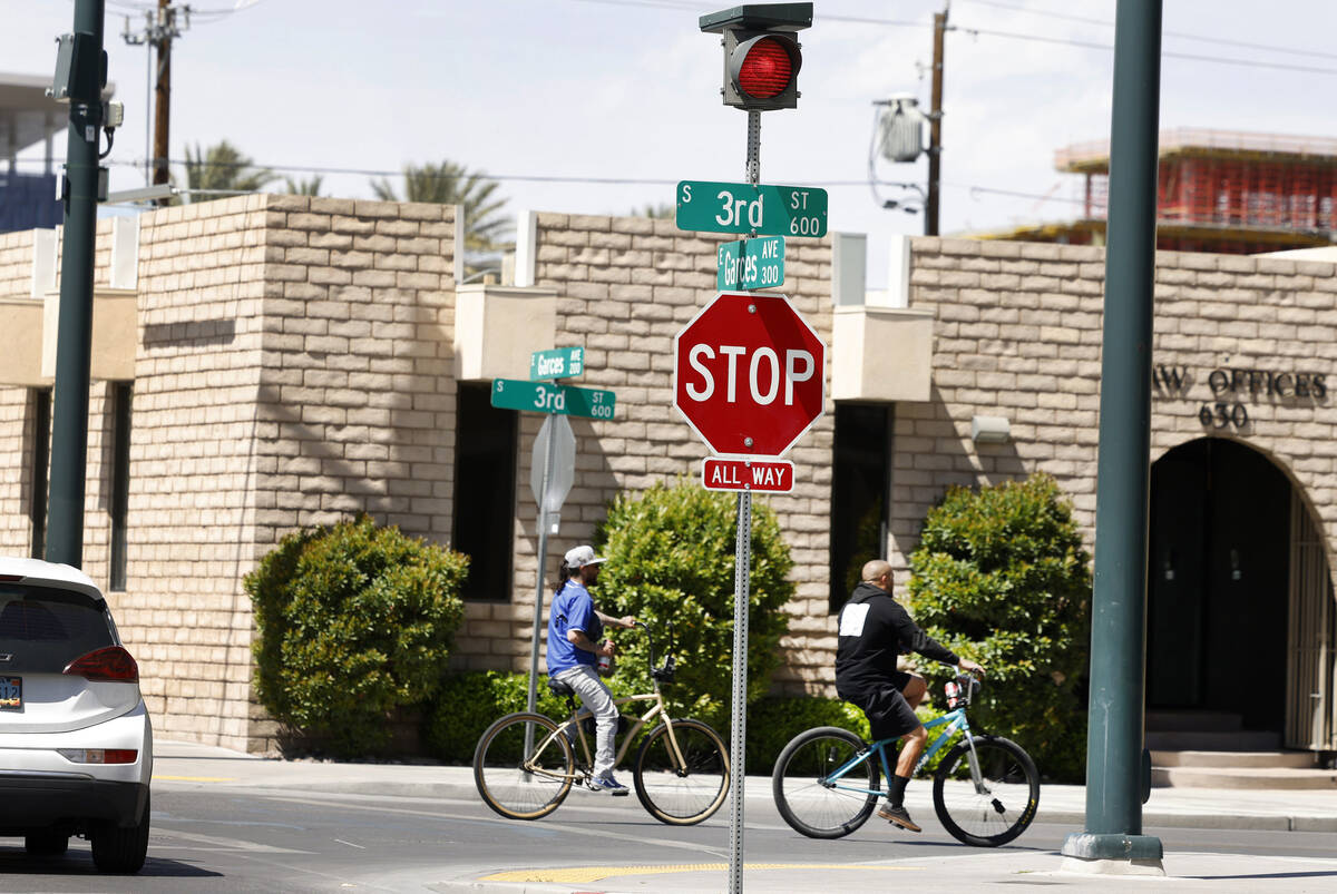 Cyclists ride past street signals recently added at the intersections of Third Street and Garce ...