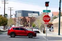 A motorist drives past street signals recently added at the intersections of Third Street and G ...