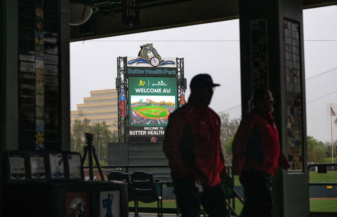 The Sutter Health Park scoreboard welcomes the Oakland Athletics as park staff members walk pas ...