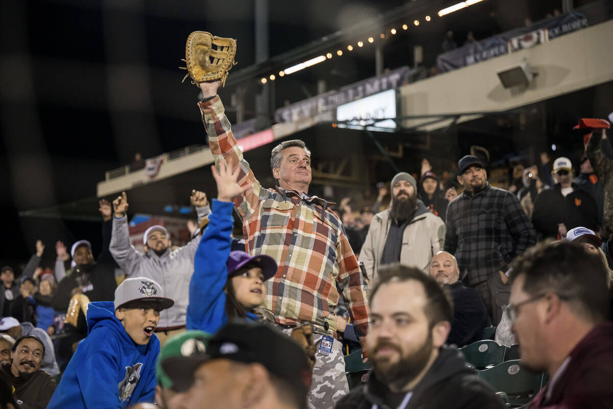 Baseball fans stand for giveaways as the Sacramento River Cats host the El Paso Chihuahuas in t ...