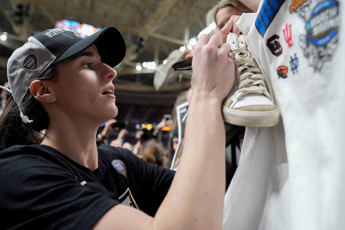 Iowa guard Caitlin Clark (22) signs autographs for fans after Iowa defeated LSU in an Elite Eig ...