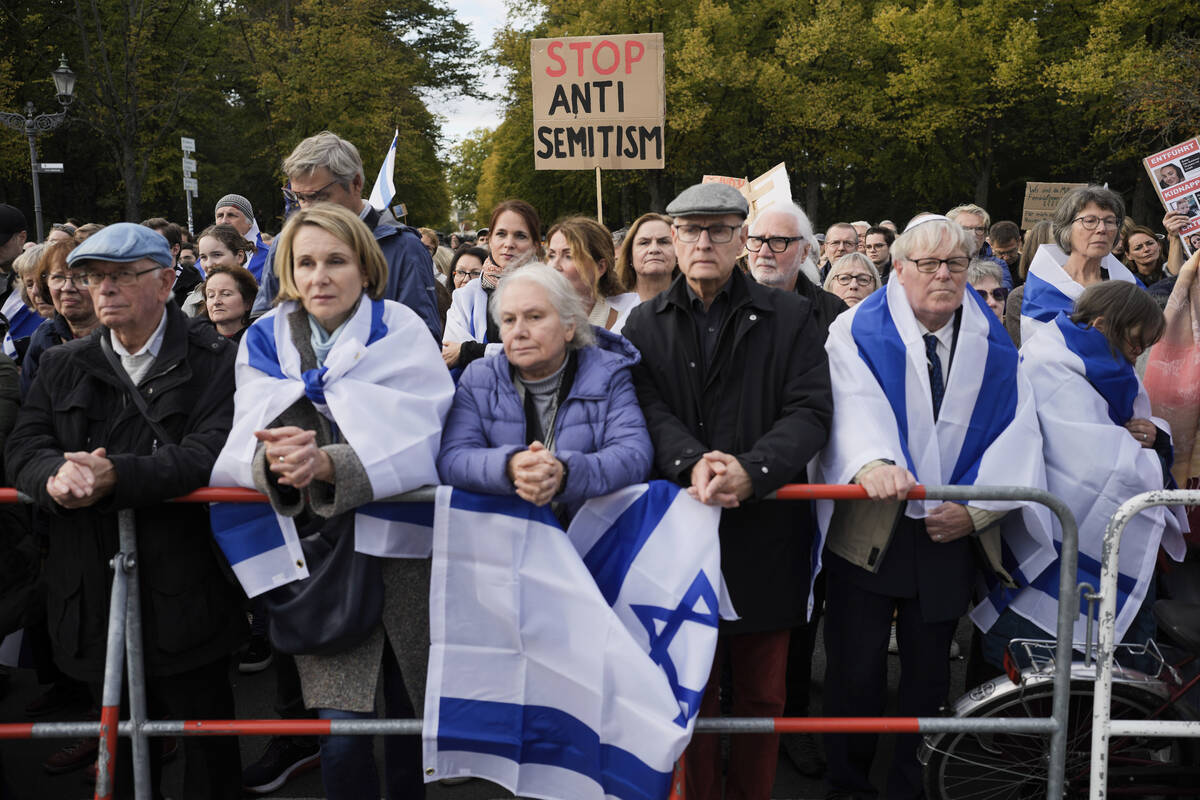 FILE - People listen to speeches during a demonstration against antisemitism and to show solida ...
