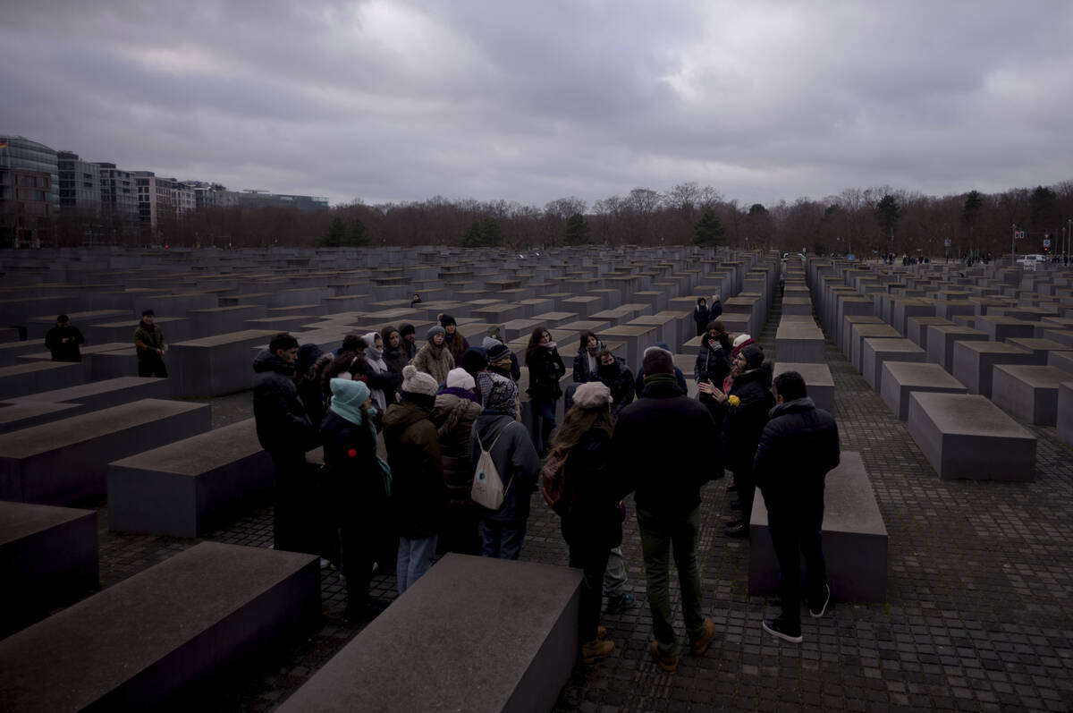 FILE - Tourists visit the Holocaust Memorial in Berlin, Germany, on International Holocaust Rem ...