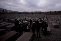 FILE - Tourists visit the Holocaust Memorial in Berlin, Germany, on International Holocaust Rem ...