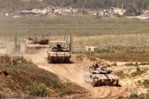 Israeli tanks move in an area along the border with the Gaza Strip and southern Israel on April ...