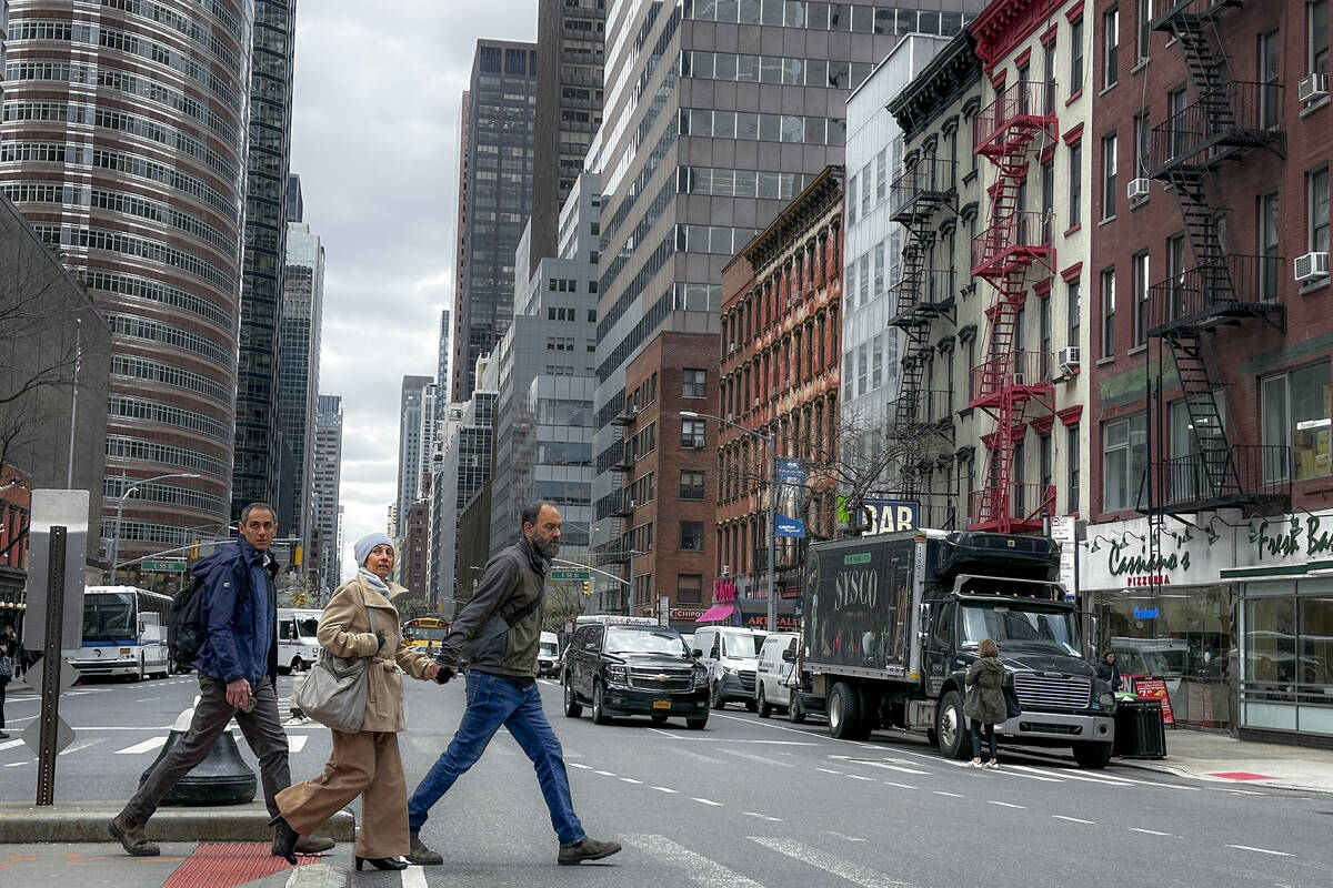 Pedestrians cross the street in New York on Friday, April 5, 2024. An earthquake shook the dens ...