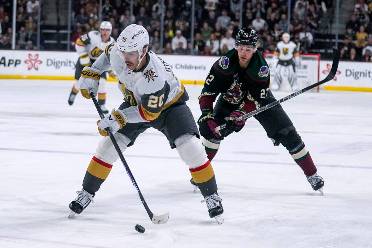 Vegas Golden Knights center Chandler Stephenson (20) controls the puck in front of Arizona Coyo ...