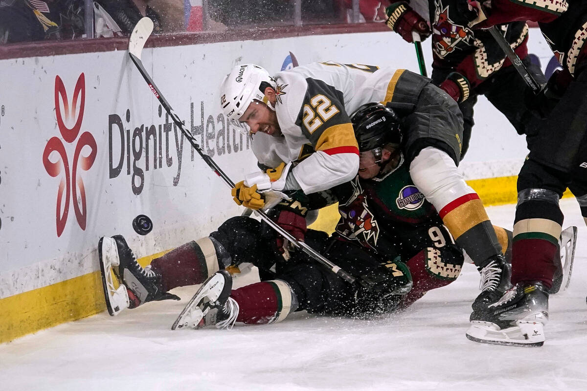Vegas Golden Knights right wing Michael Amadio (22) falls onto Arizona Coyotes right wing Clayt ...