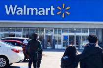 Shoppers walk to a Walmart in Vernon Hills, Ill., Tuesday, March 28, 2023. If you purchased so ...