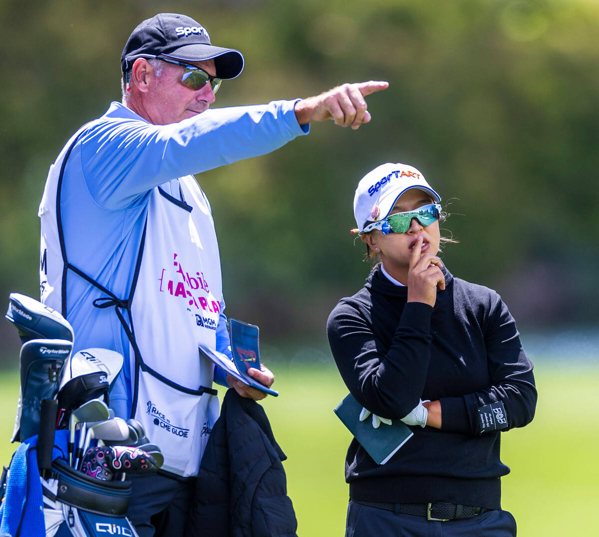 Sei Young Kim talks about her next shot with her caddie Paul Fusco on hole #3 during the third ...