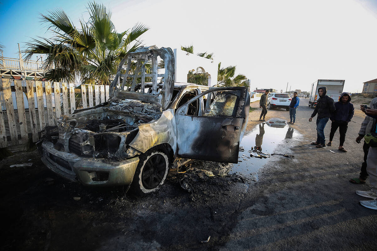 Palestinians are standing next to a vehicle in Deir Al-Balah, in the central Gaza Strip, on Apr ...