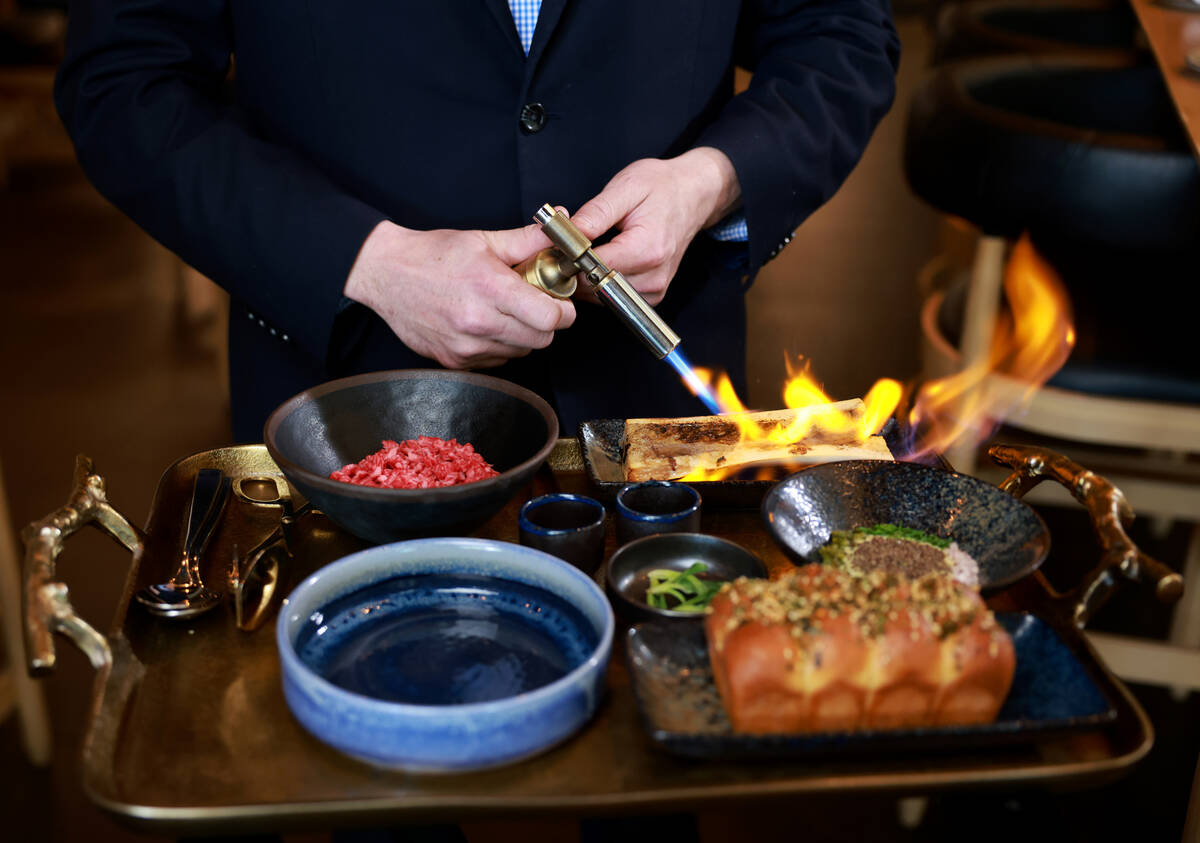 Wagyu bone marrow tartare with Japanese milk bread is prepared tableside at KYU, an American ba ...