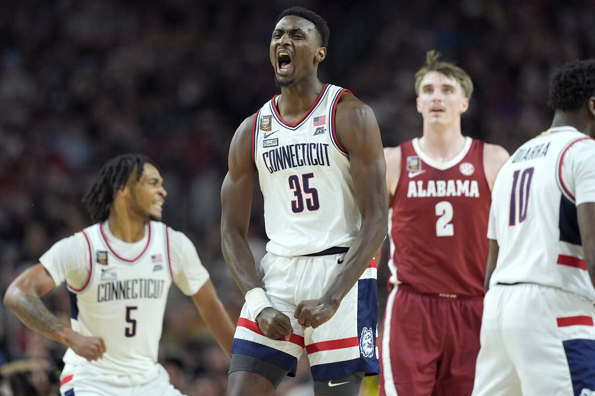 UConn forward Samson Johnson celebrates a basket during the second half of the NCAA college bas ...