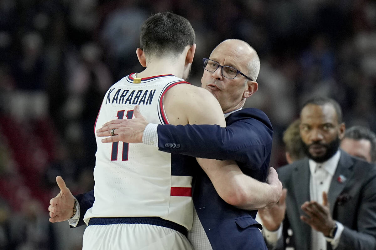 UConn head coach Dan Hurley embraces forward Alex Karaban (11) during the second half of the NC ...