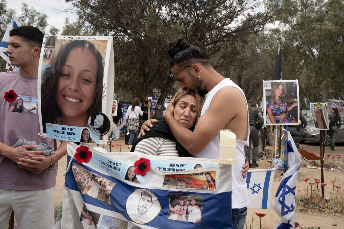 Relatives of a young woman killed in a cross-border attack by Hamas that killed or kidnapped hu ...
