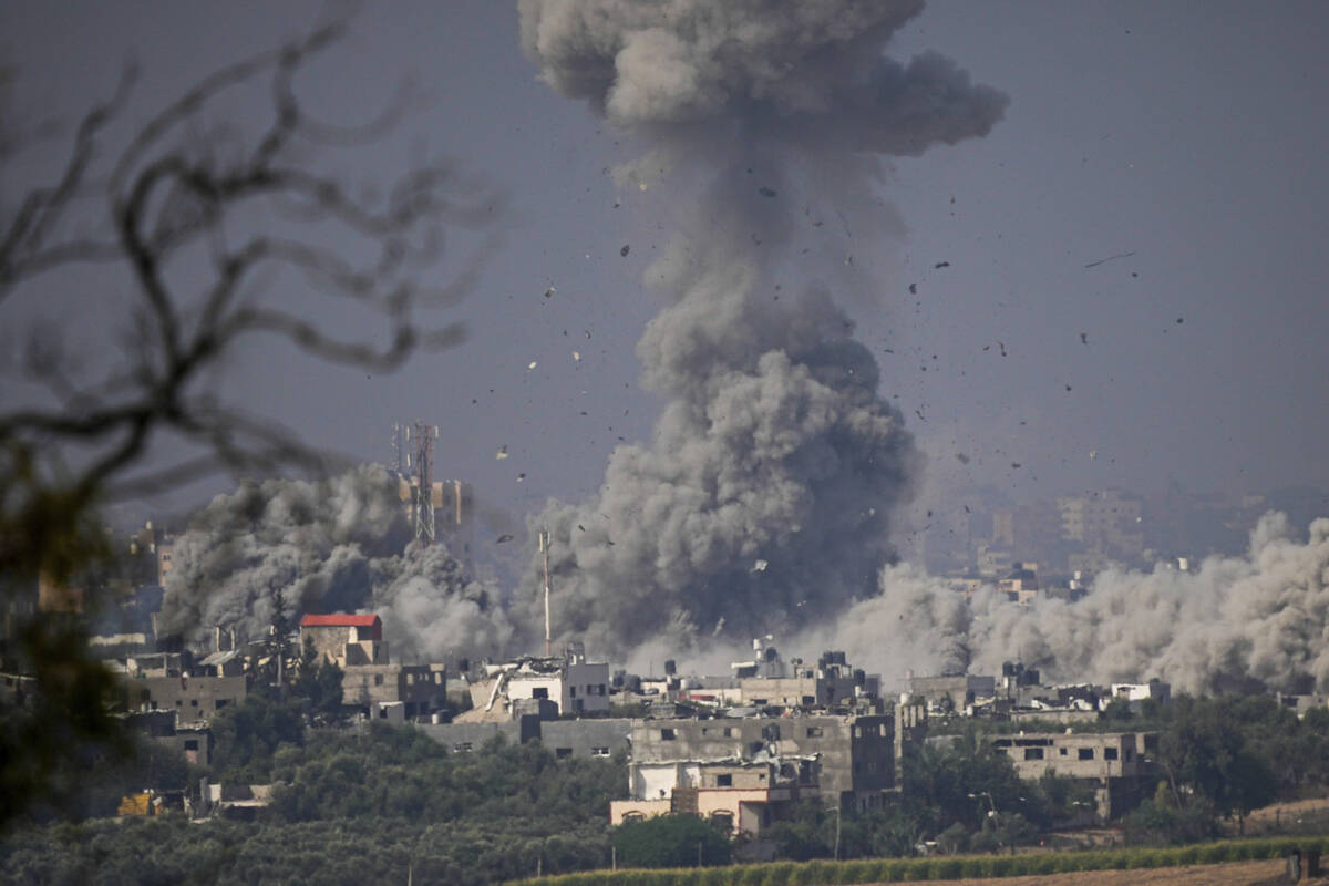 Smoke rises following an Israeli airstrike in the Gaza Strip, as seen from southern Israel, Mon ...