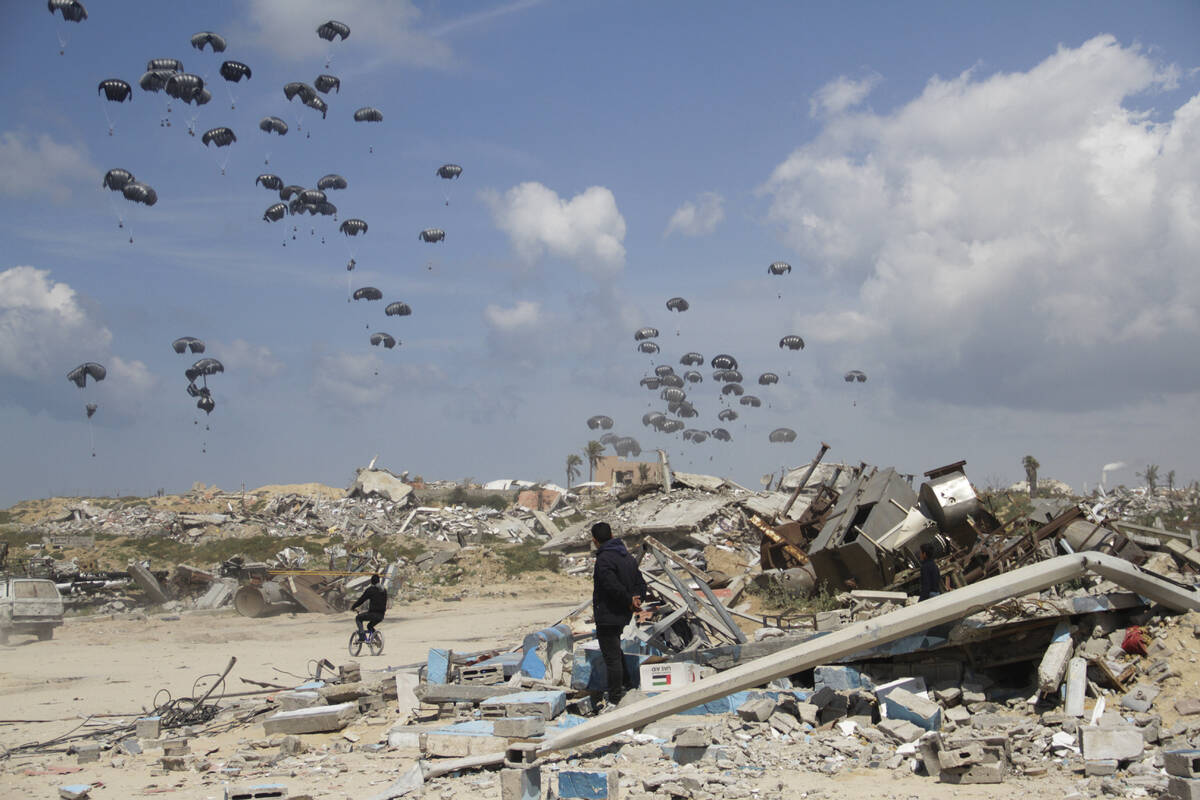 Humanitarian aid is airdropped to Palestinians over Gaza City, Gaza Strip, Monday, March 25, 20 ...