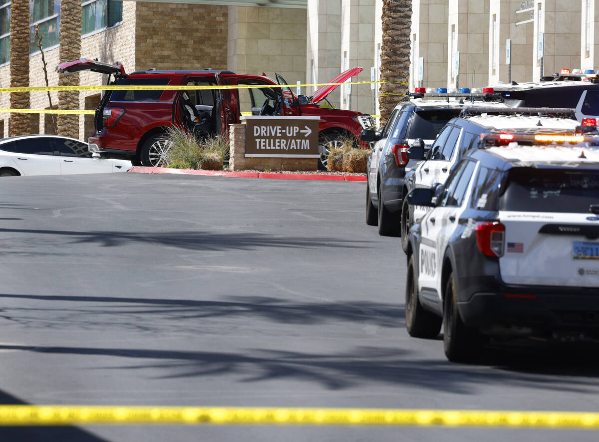 An SUV is seen at the scene as Las Vegas police investigate a shooting at City National Bank Bu ...