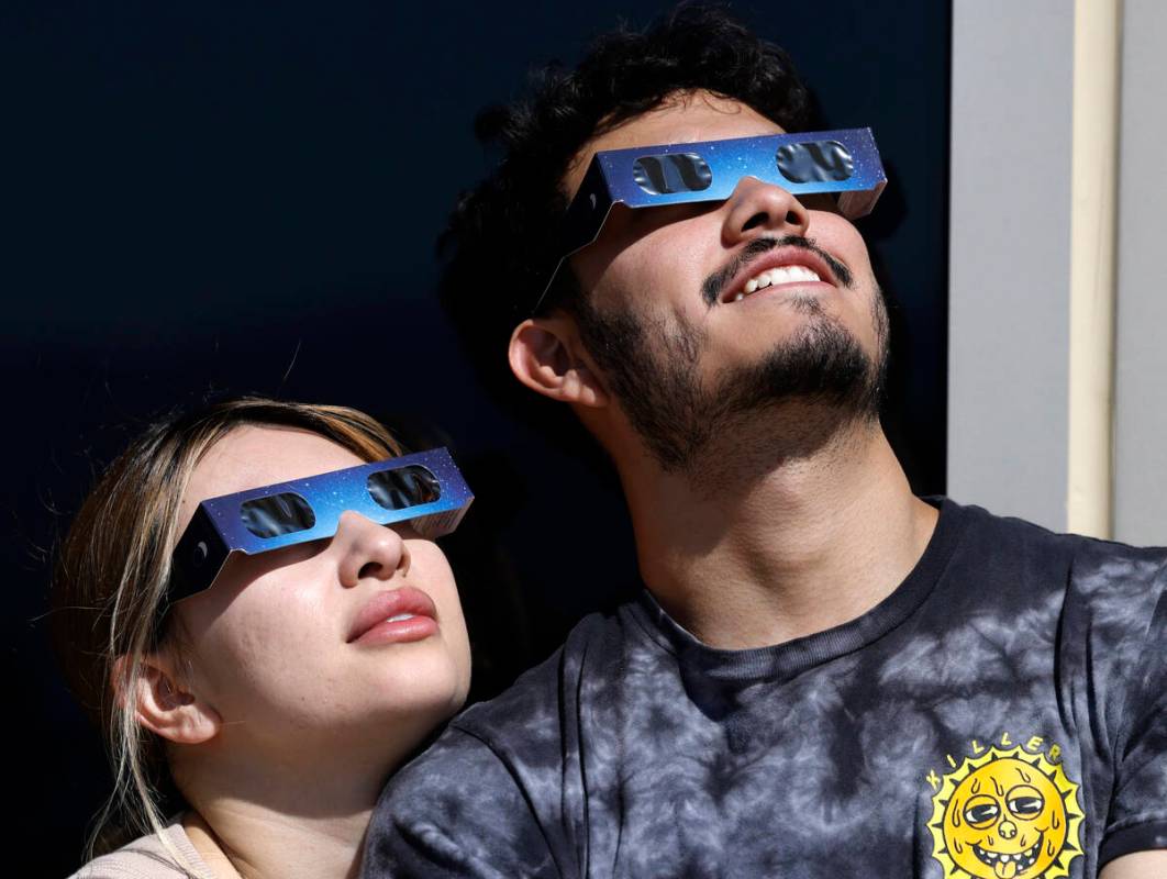 Chris Tejeda and his girlfriend, Valentina Cernas, watch a partial solar eclipse at the observa ...