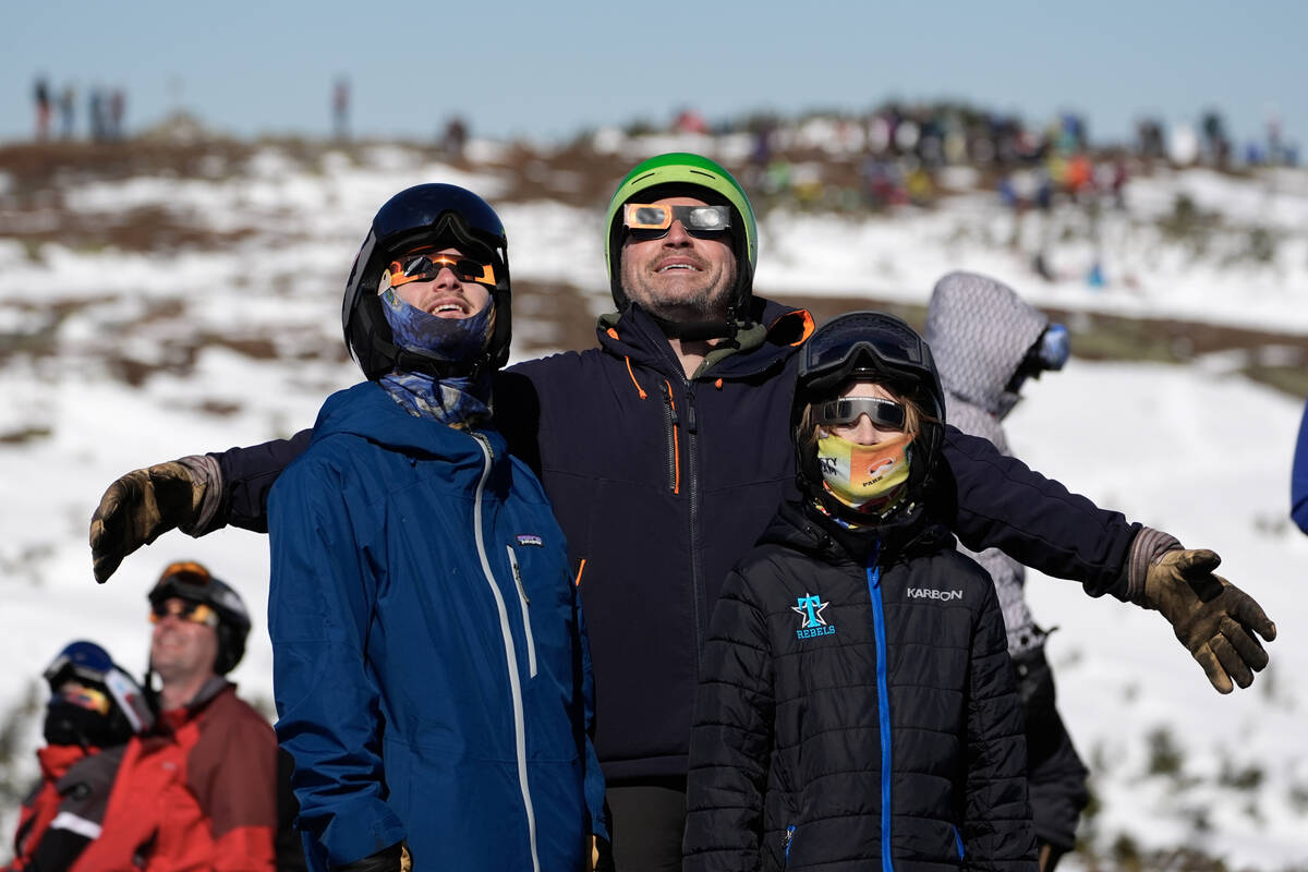 Skiers and hikers watch the moon move in front of the sun from the Appalachian Trail at the sum ...