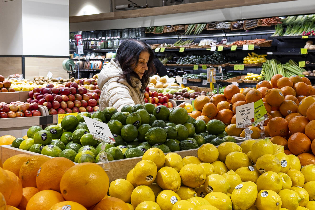 A woman browses produce for sale at a grocery store, Friday, Jan. 19, 2024, in New York. In fin ...