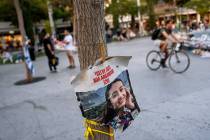 A poster depicting Israeli hostage Noa Argamani, 26, is displayed next to a memorial in Tel Avi ...