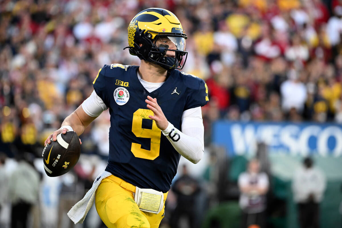 Michigan quarterback J.J. McCarthy (9) rolls out during the second half of the Rose Bowl CFP NC ...