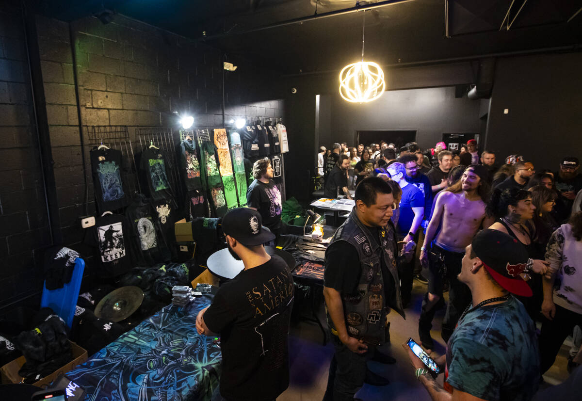 Attendees browse through band merchandise during a concert at the newly-opened venue Sinwave on ...