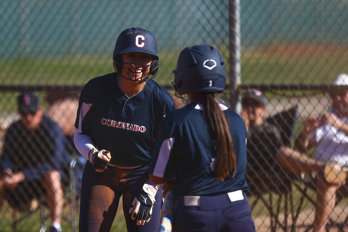 Coronado's Sarah Lopez, left, and Summer Gilliam celebrate a run during a high school softball ...