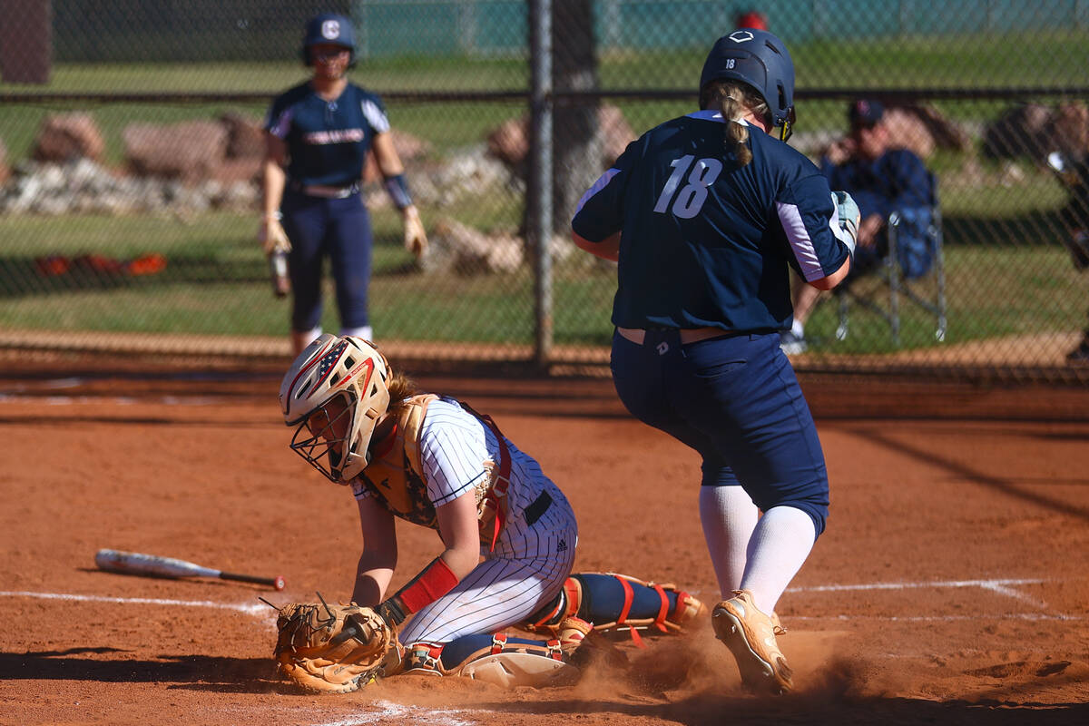 Coronado's Madison Norcross (18) scores a run while Liberty's Justice Lavin (77) attempts to ou ...