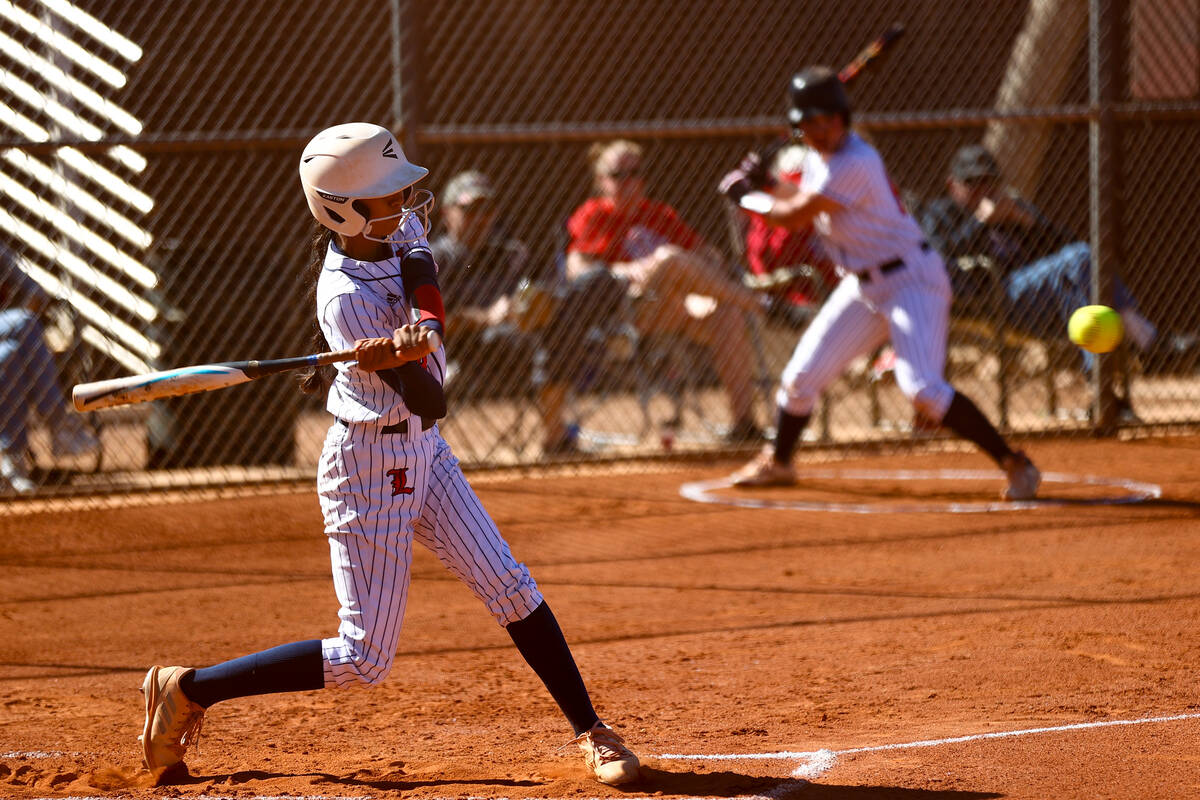 Liberty's Logan Sanford (14) winds up to swing on a Coronado pitch during a high school softbal ...