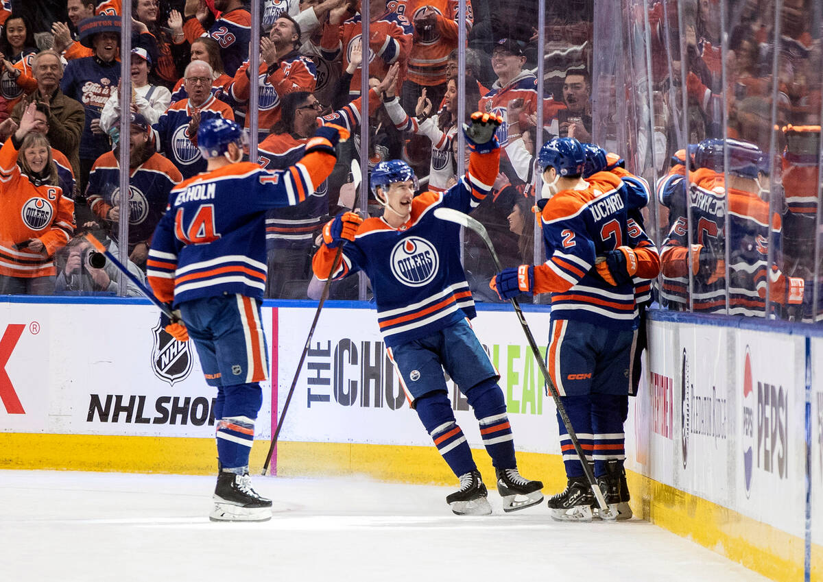 Edmonton Oilers' Mattias Ekholm (14), Ryan McLeod (71), Dylan Holloway (55) and Evan Bouchard ( ...