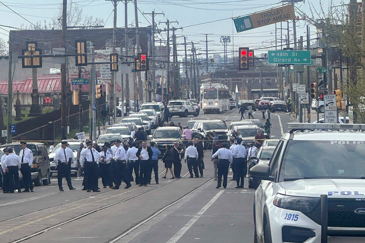 People gather in the aftermath of a shooting at an Eid al-Fitr event in Philadelphia, Wednesday ...