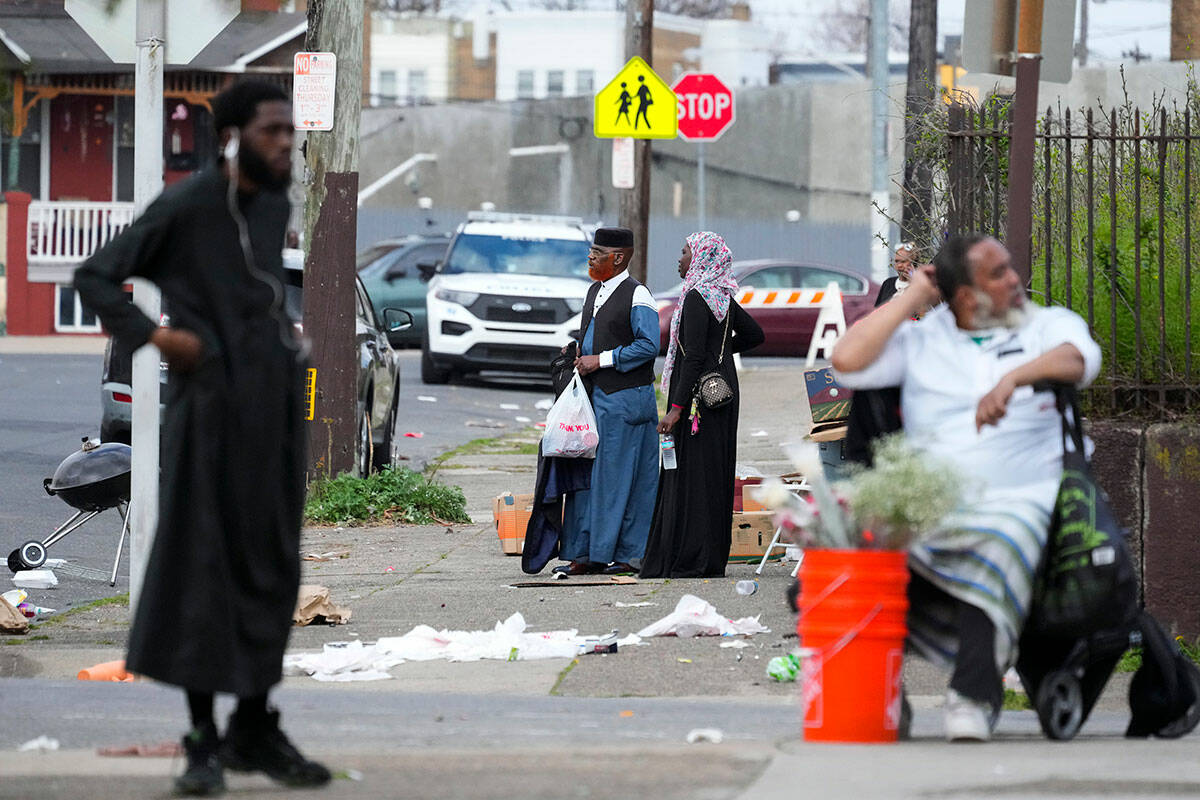 People gather in the aftermath of a shooting at an Eid al-Fitr event in Philadelphia, Wednesday ...
