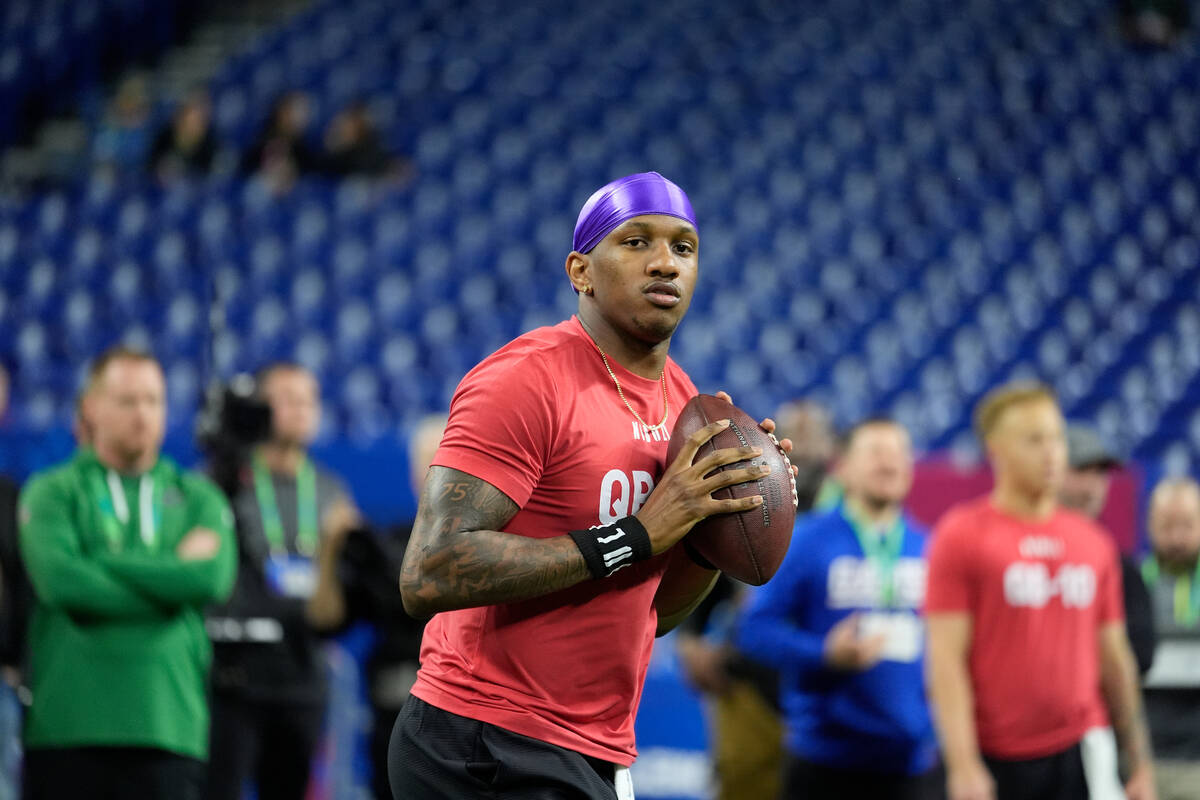 Washington quarterback Michael Penix runs a drill at the NFL football scouting combine, Saturda ...