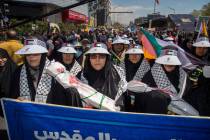 People attend the funeral procession for seven Islamic Revolutionary Guard Corps members killed ...