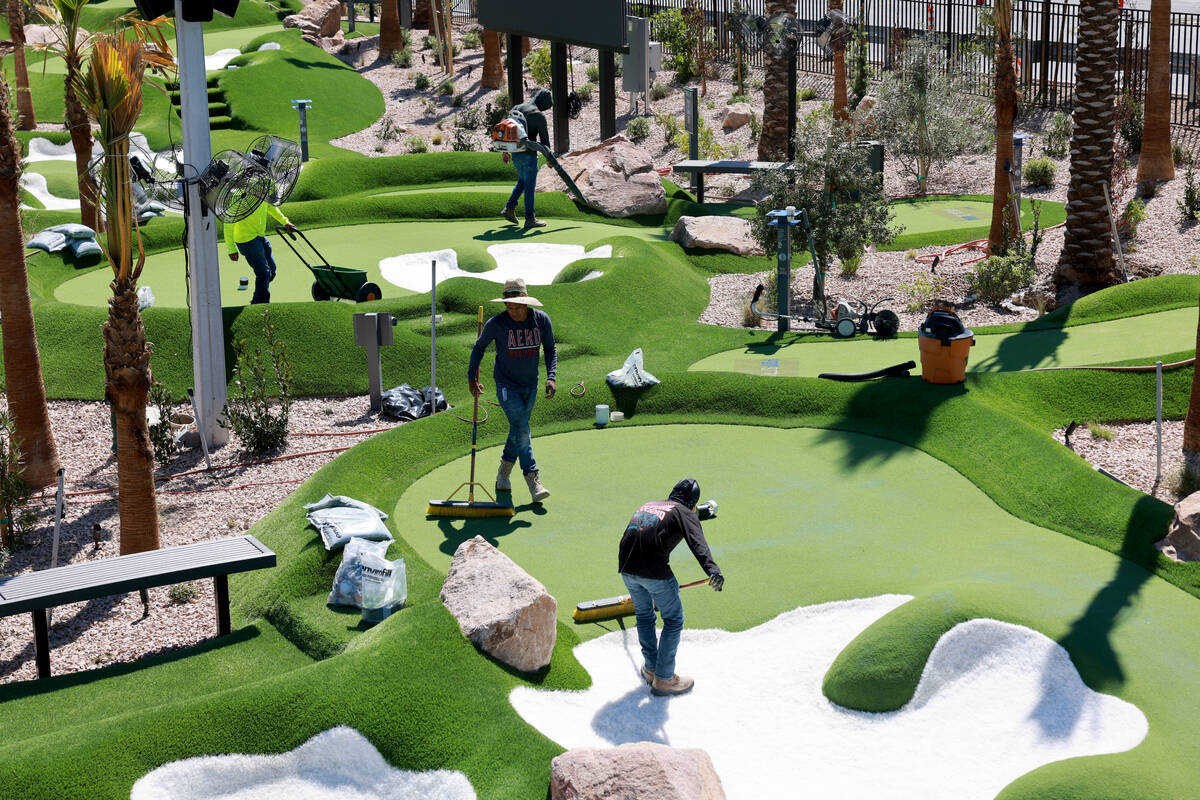 Workers put the finishing touches PopStroke mini-golf and entertainment facility at Town Square ...