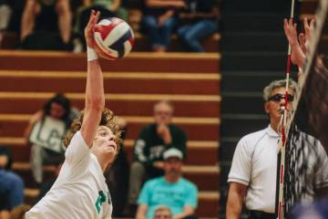 Green Valley outside hitter Brock Barney hits the ball over the net during a volleyball match b ...