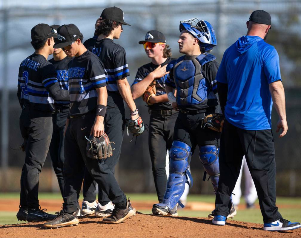 Basic infielder come together at the pitching mound as Spring Valley loads the bases during the ...