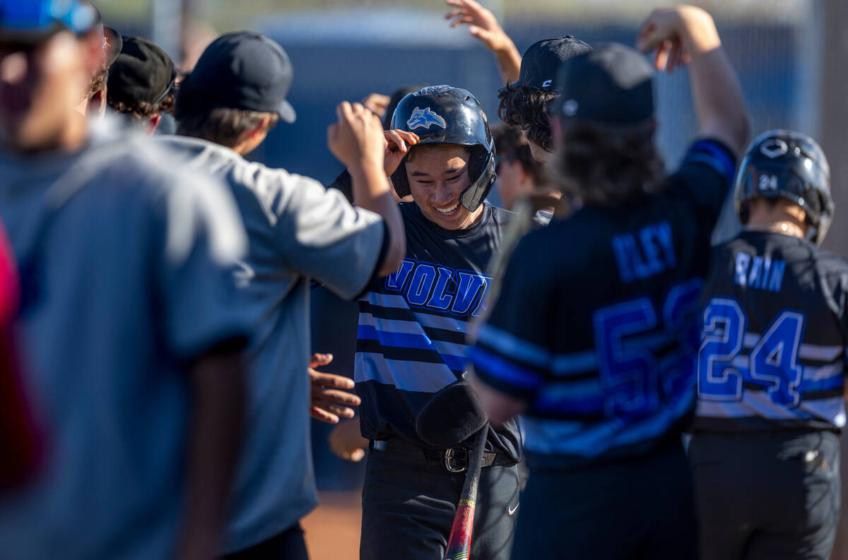 Basic players celebrate more runs against Spring Valley during the sixth inning of their NIAA b ...